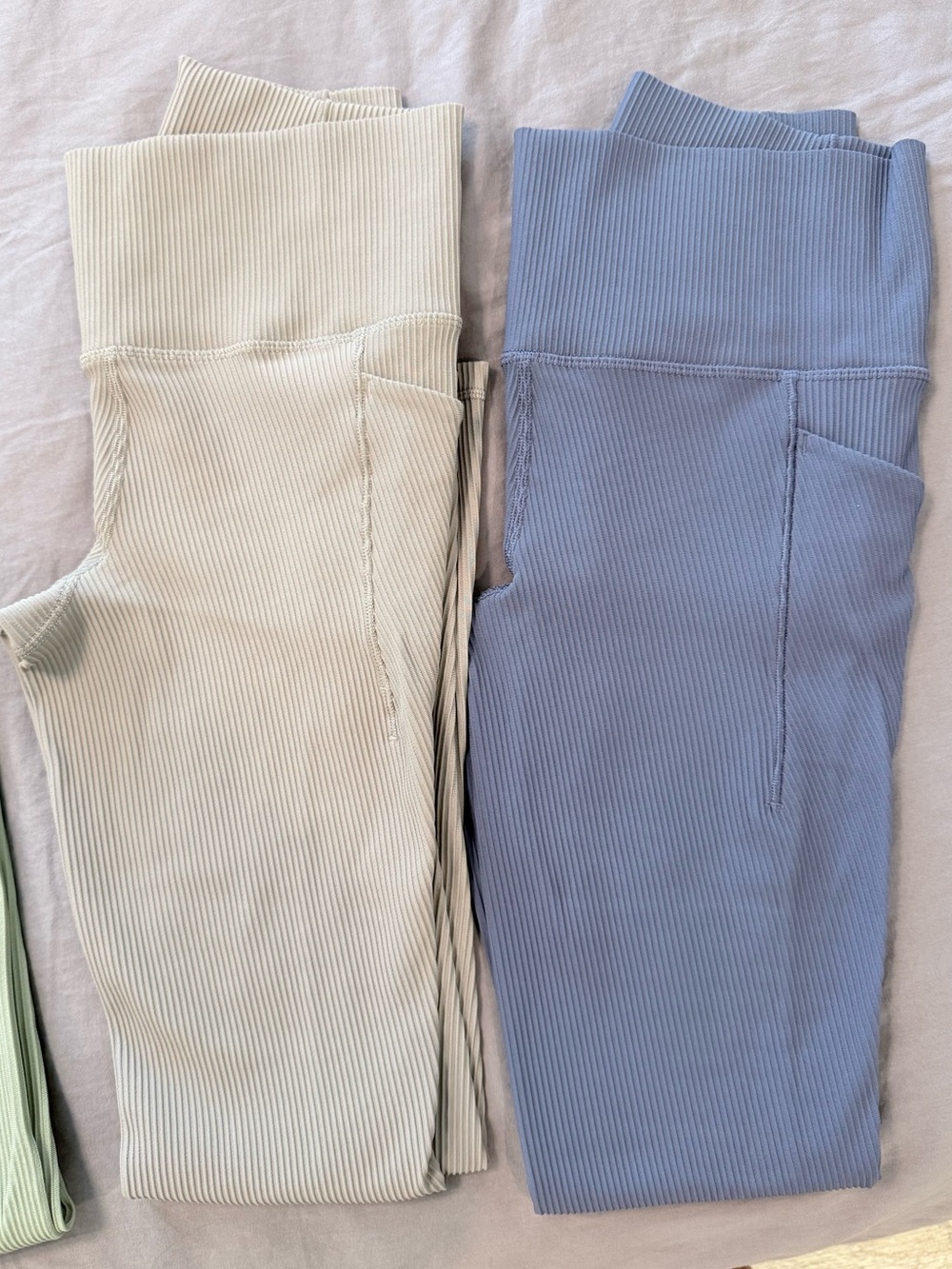 Athleta women’s rib salutation 7/8 tight, stash pockets in buff and purple-blue.